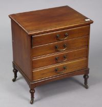 An Edwardian small mahogany sheet-music cabinet fitted four long drawers with hinged fall-