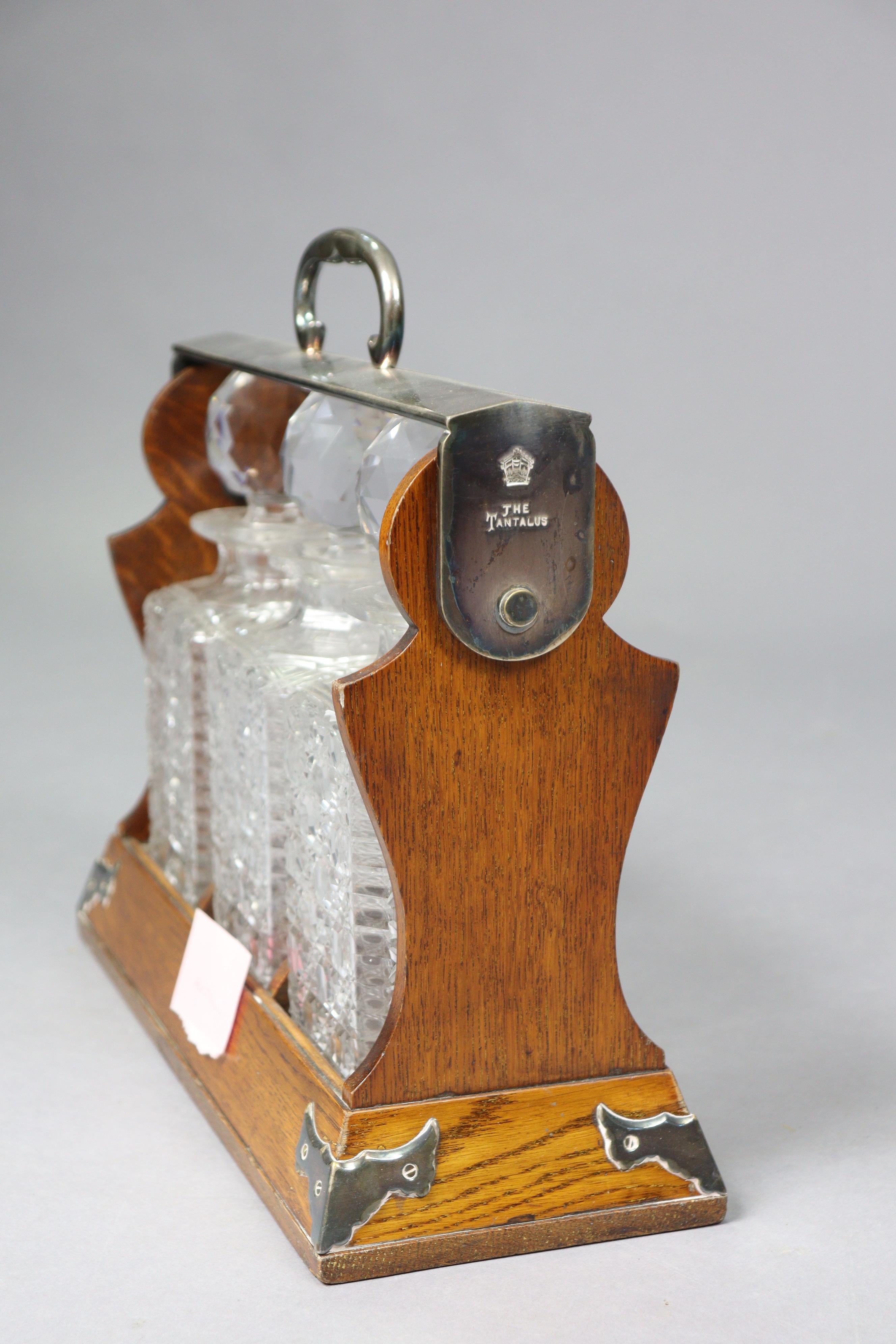 A late 19th century Betjaman’s patent oak tantalus having plated mounts, & fitted three cut-glass - Image 4 of 8