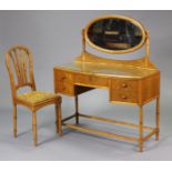 A 1920’s/1930’s art deco inlaid dressing table fitted with an arrangement of five drawers, on turned