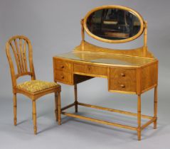 A 1920’s/1930’s art deco inlaid dressing table fitted with an arrangement of five drawers, on turned