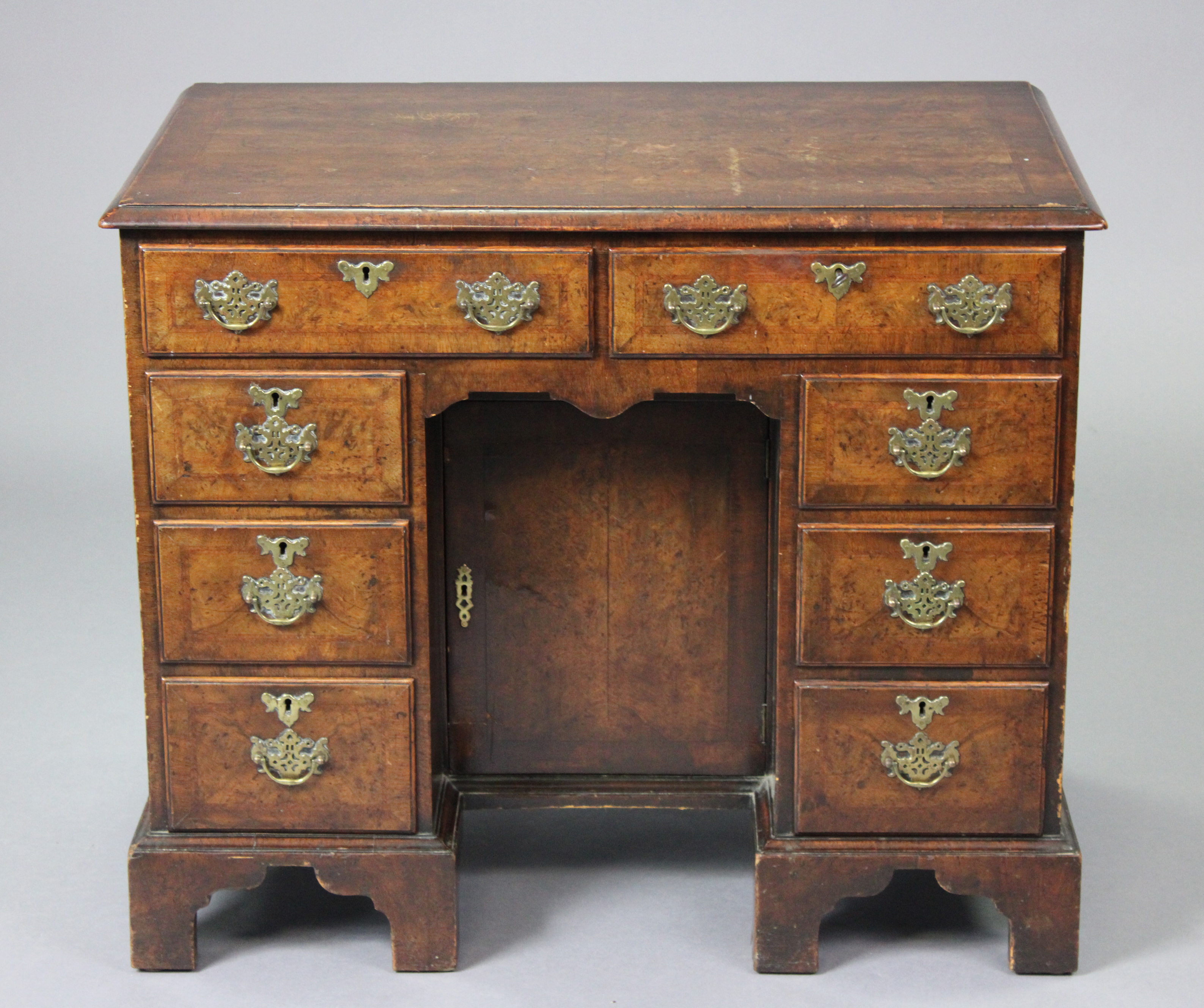 A Georgian walnut knee-hole desk with crossbanding & herring-bone inlay, fitted with an