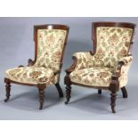 A pair of Victorian carved walnut ladies’ & gents’ easy chairs with velour upholstery, on turned