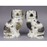 A pair of 19thC Staffordshire pottery flat back spaniel ornaments, each 24cm high x 14cm wide.