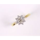 An 18ct. gold ring set cluster of small diamonds, the centre stone approx. 0.2 carat; size: N, 2.