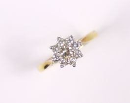 An 18ct. gold ring set cluster of small diamonds, the centre stone approx. 0.2 carat; size: N, 2.