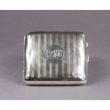 A George V silver cigarette case with engine-turned decoration & engraved initials: “P. W. H.”,