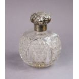 An Edwardian large cut glass spherical toilet-water bottle with silver collar & embossed hinged cap,
