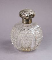 An Edwardian large cut glass spherical toilet-water bottle with silver collar & embossed hinged cap,