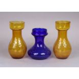 A pair of late 19th/early 20th century yellow glass hyacinth vases of ovoid shape, 18cm, & a similar