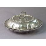 A LATE VICTORIAN SILVER ENTRÉE DISH of lobed circular form with gadrooned rims, the cover with
