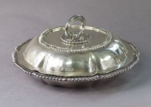 A LATE VICTORIAN SILVER ENTRÉE DISH of lobed circular form with gadrooned rims, the cover with