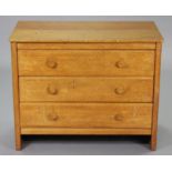 A GORDON RUSSELL LTD OAK ‘DENBIGH’ CHEST fitted three long drawers with turned handles, on plain end