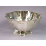 An Art Deco silver square deep bowl with fluted corners, on conforming foot, 20cm wide x 1cm high;
