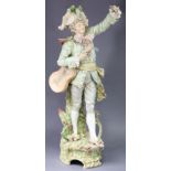 A large continental porcelain figure of a musician, holding a guitar with one arm raised, on