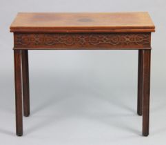 A George III mahogany tea table with fold-over top & blind fret-carved frieze, on square chamfered