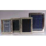 A modern silver plain rectangular photograph frame, 22cm x 17cm, Sheffield 1986; & three similar
