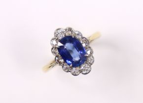 A SAPHIRE & DIAMOND RING, the oval-cut sapphire measuring approx. 9mm x 6.5 x 4mm, within a border