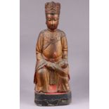 A Chinese polychrome & gilt lacquer carved wooden model of Buddha & attendant, on black painted