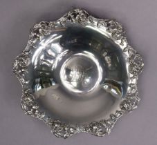 A Tiffany & Co. sterling circular shallow dish, the cast & pierced shaped rim decorated with