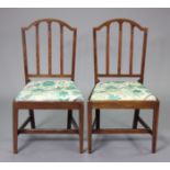 A pair of early 19th century inlaid mahogany dining chairs with shaped rail backs & padded drop-in