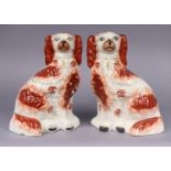 A pair of 19thC Staffordshire pottery large flat-back models of seated spaniels, each 31cm high x