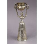 A late 19th century continental silver (.930 standard) Wager cup, the female figure of traditional