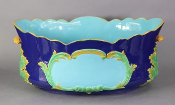 A MINTON MAJOLICA OVAL JARDINIERE, of deep blue ground with turquoise interior & cartouche to each