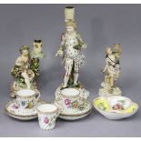 An 18th century Derby porcelain candlestick with seated putto & floral bocage, a loop handle to rear