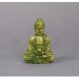 A Chinese carved jadeite pendant in the form of a seated buddha, 5.7cm high.