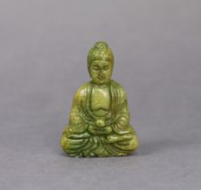 A Chinese carved jadeite pendant in the form of a seated buddha, 5.7cm high.