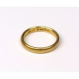 A 22ct. gold wedding band, Birmingham hallmarks for 1926; size: O; 5.4gm.