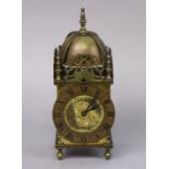 A 17th century style brass lantern clock, the scroll-engraved gilt dial inscribed “Wilson & Gill,