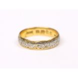 A 22ct. gold wedding band; size: L/M. (3.8gm).