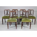 A set of six mid-Victorian walnut dining chairs, the square gothic open backs centred by a