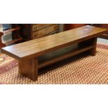 A modern hardwood low hall table of simple rectangular shape, on square end supports with centre