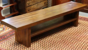 A modern hardwood low hall table of simple rectangular shape, on square end supports with centre