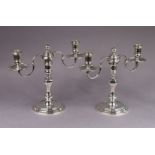 A pair of silver queen Anne style dwarf table candelabra, each with square baluster column