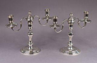 A pair of silver queen Anne style dwarf table candelabra, each with square baluster column