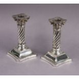 A pair of late Victorian silver dwarf candlesticks with removable drip-pans, the spiral fluted