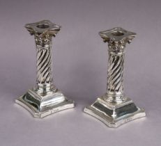 A pair of late Victorian silver dwarf candlesticks with removable drip-pans, the spiral fluted