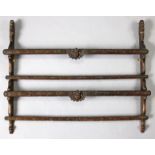 A continental elm two-tier open plate rack carved with cherub-masks, grotesques & scroll decoration,