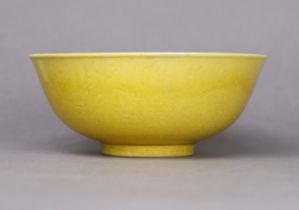 A Chinese porcelain yellow-ground ‘dragon’ bowl, the exterior carved with encircling dragons chasing