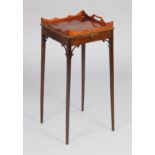 A George III style mahogany urn stand with pierced handles to the shaped tray-top, brushing slide,