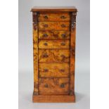 A Victorian walnut Wellington chest with carved leaf scroll decoration, fitted seven graduated