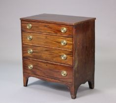 A 19th century mahogany small chest fitted four long graduated drawers with brass oval swing