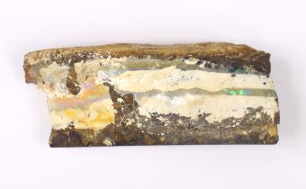 A large natural geological specimen bearing layers of opal, approx. 11cm x 5cm.
