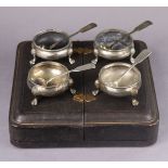 A set of four Victorian silver squat round salt cellars with engraved decoration & beaded rims, each