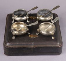 A set of four Victorian silver squat round salt cellars with engraved decoration & beaded rims, each