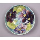 A Moorcroft pottery clematis pattern large bowl of pale blue/green ground, 26cm dia. x 8.4cm high,