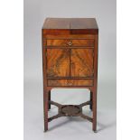 A Regency mahogany washstand with bi-fold top enclosing a fitted interior, a cupboard & frieze